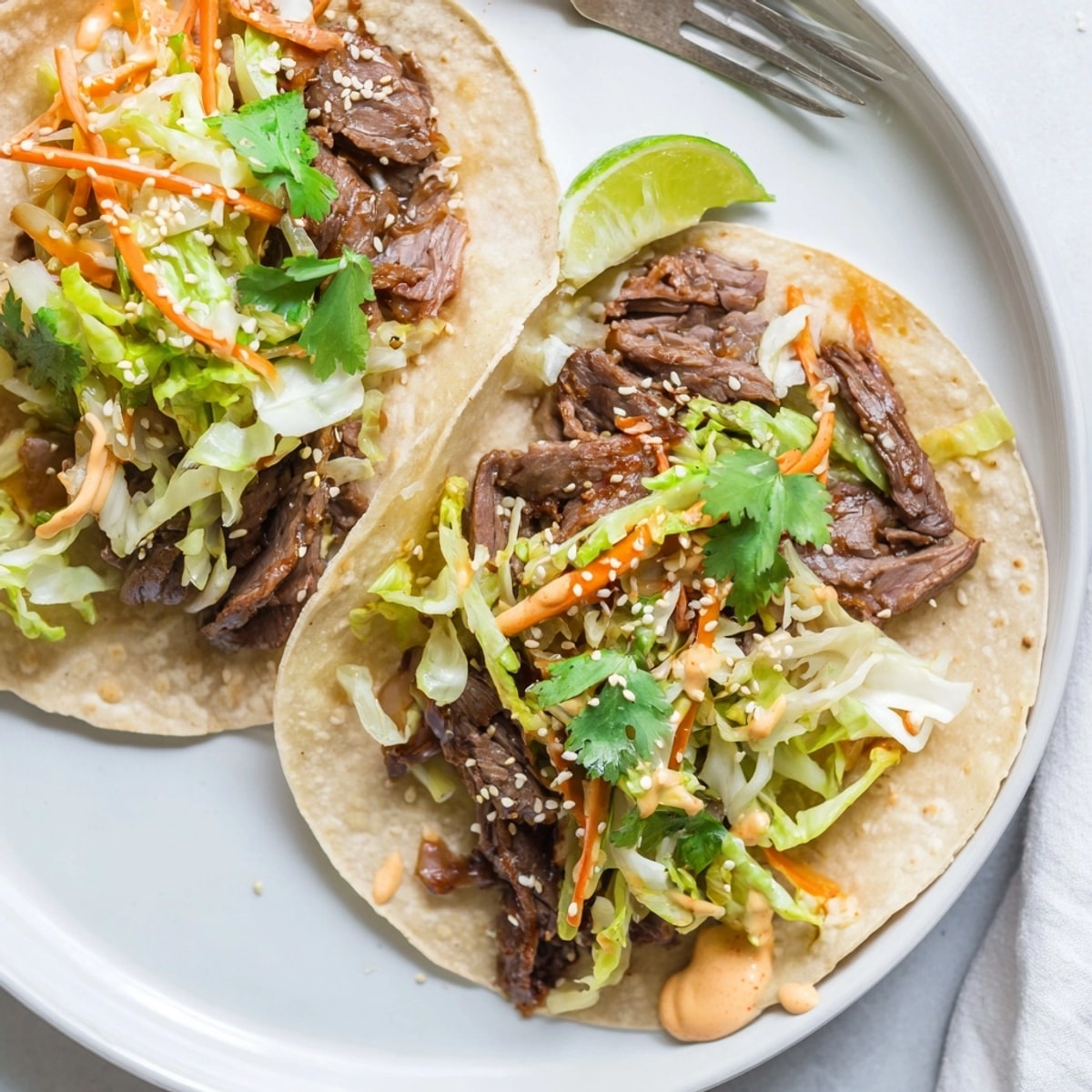 Close-up of juicy Korean BBQ Beef Tacos with Kimchi, ready for a flavorful bite.