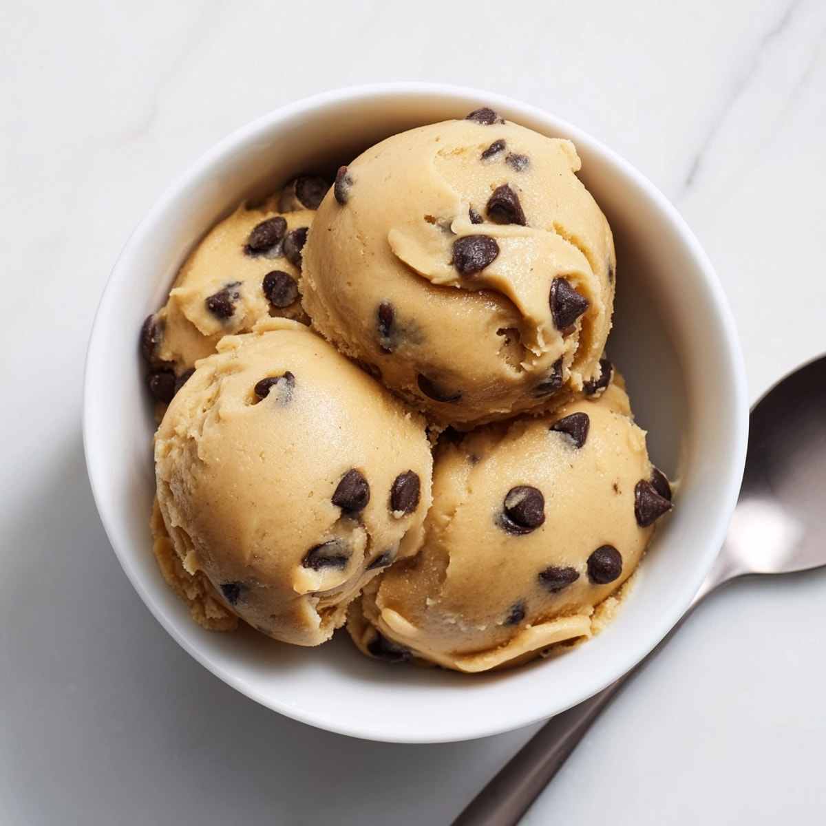Homemade edible cookie dough swirled in a bowl, a delicious safe-to-eat treat with comforting textures.