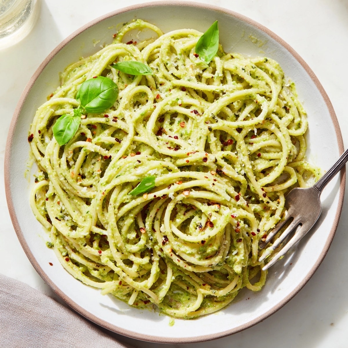Top-down view of Creamy Avocado Pasta, showcasing its vibrant sauce and fresh ingredients.