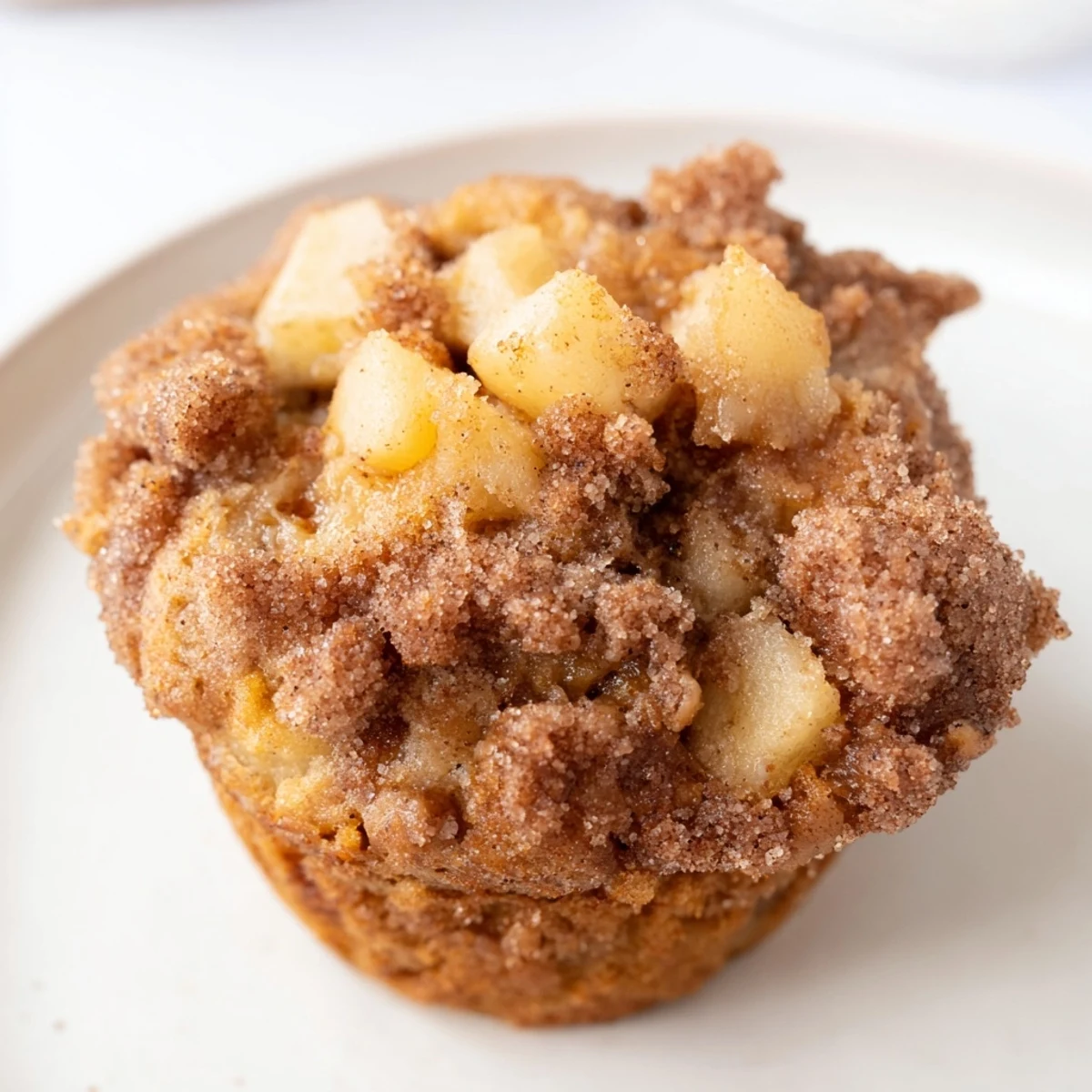 Freshly baked Cinnamon Apple Muffins with crispy cinnamon-sugar topping, perfect for brunch.