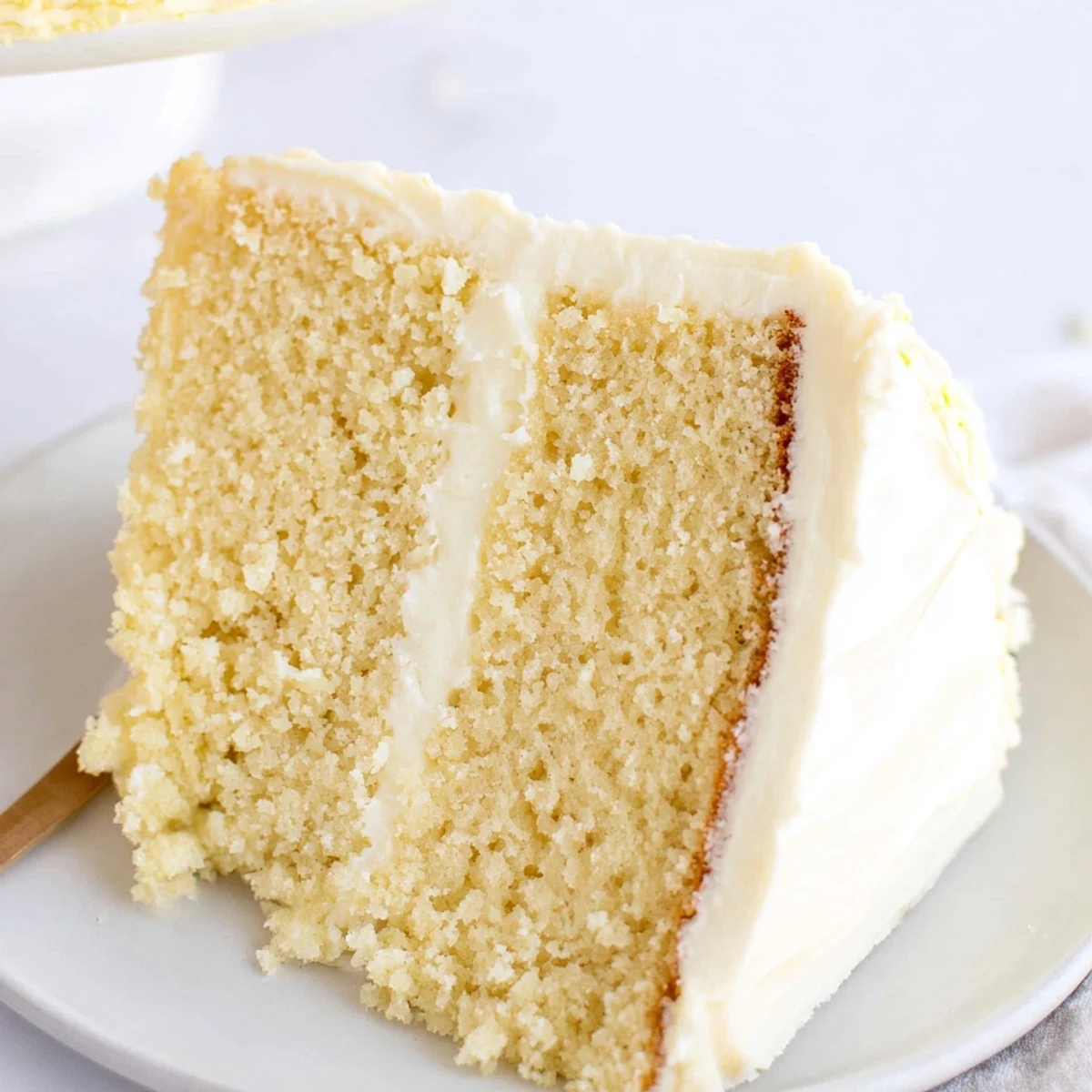 A close-up of a perfectly frosted vanilla cake, ready to serve and enjoy with friends.