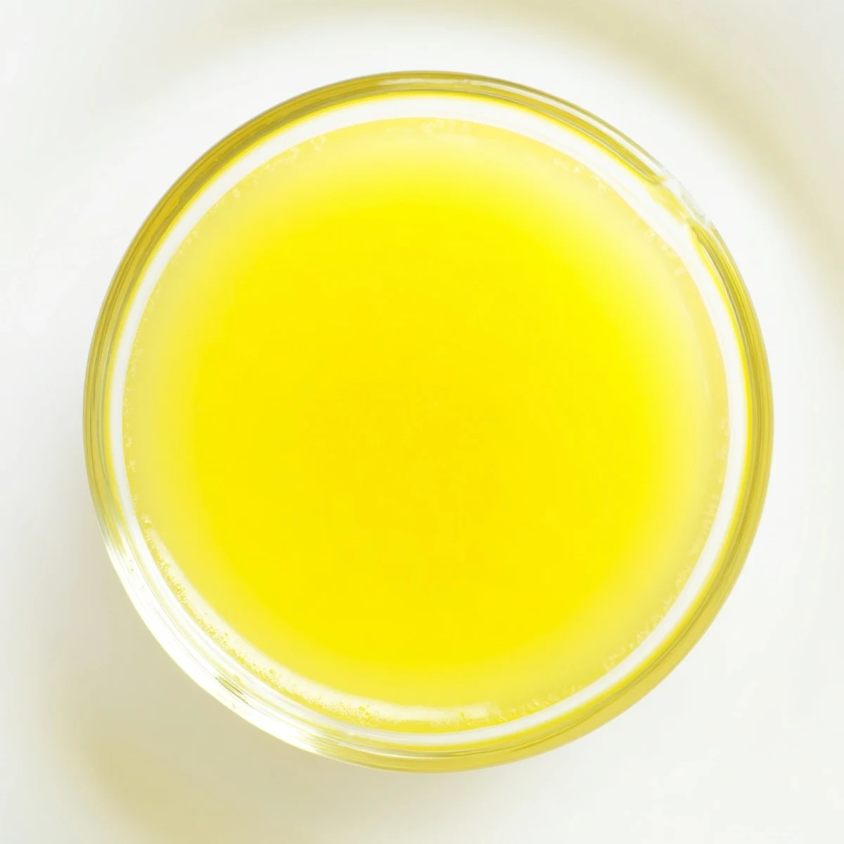 Freshly squeezed lemon juice, a vibrant yellow liquid, ready for your favorite recipes.