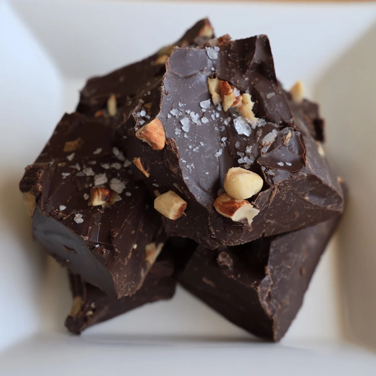 Homemade chunk chocolate with roasted nuts and dried fruit, a perfect dessert, ready to serve.