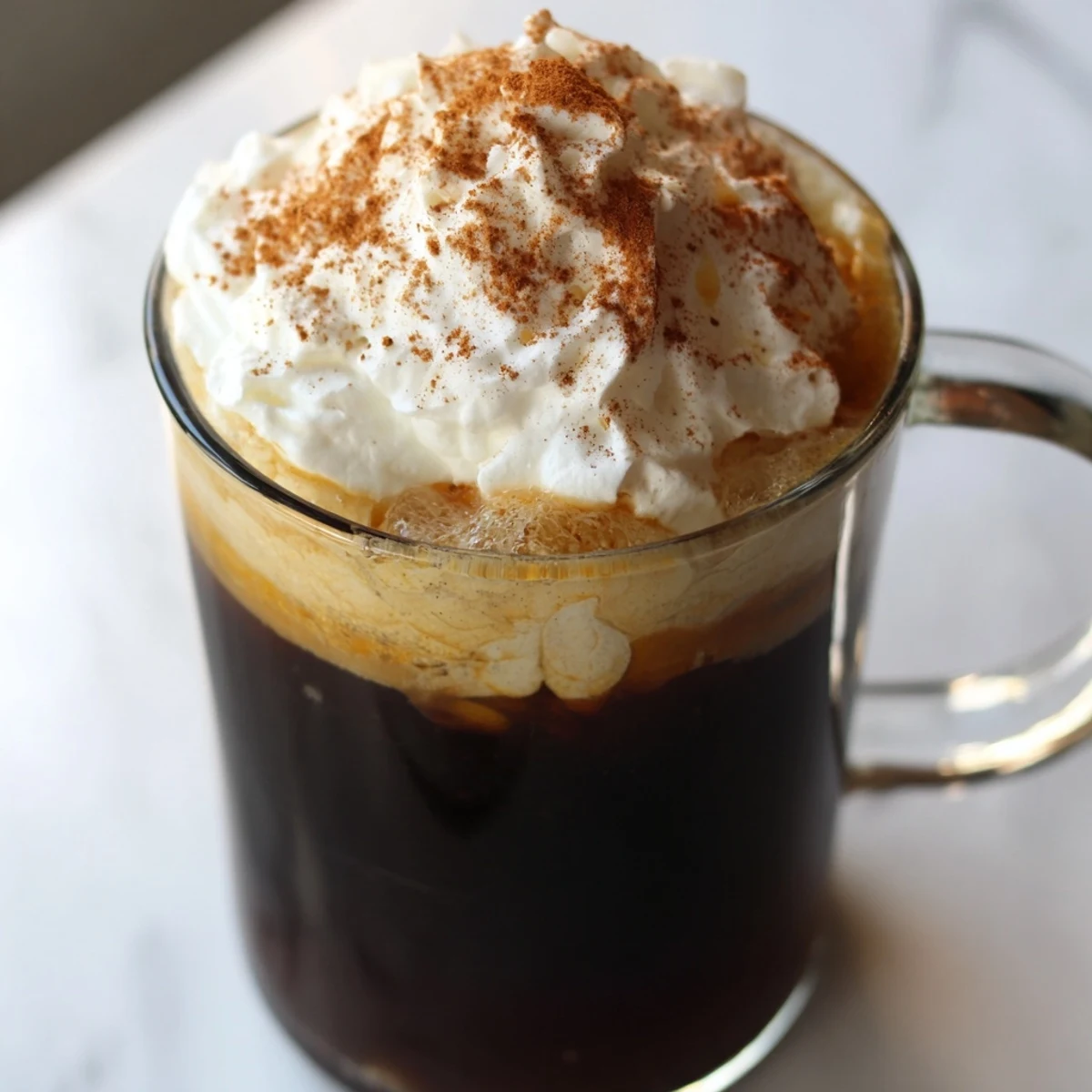 Steaming Spiced Pumpkin Latte in a cozy mug, a warm autumn drink's rich aroma.