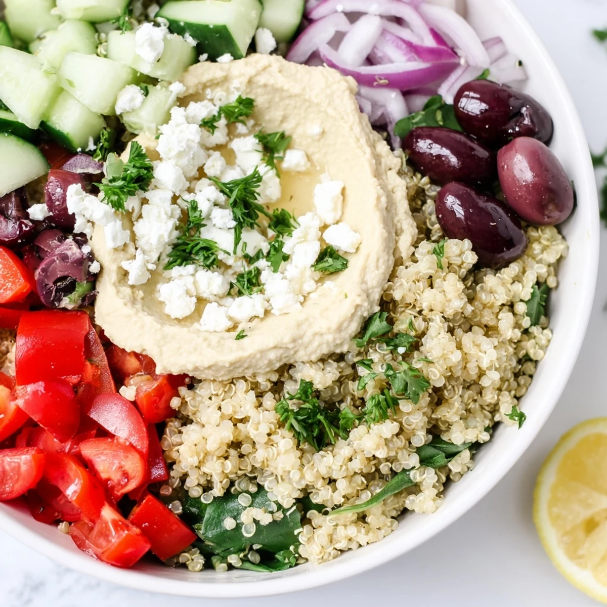 This delicious Mediterranean Quinoa Bowl includes fluffy quinoa, fresh vegetables, and a flavorful dressing.