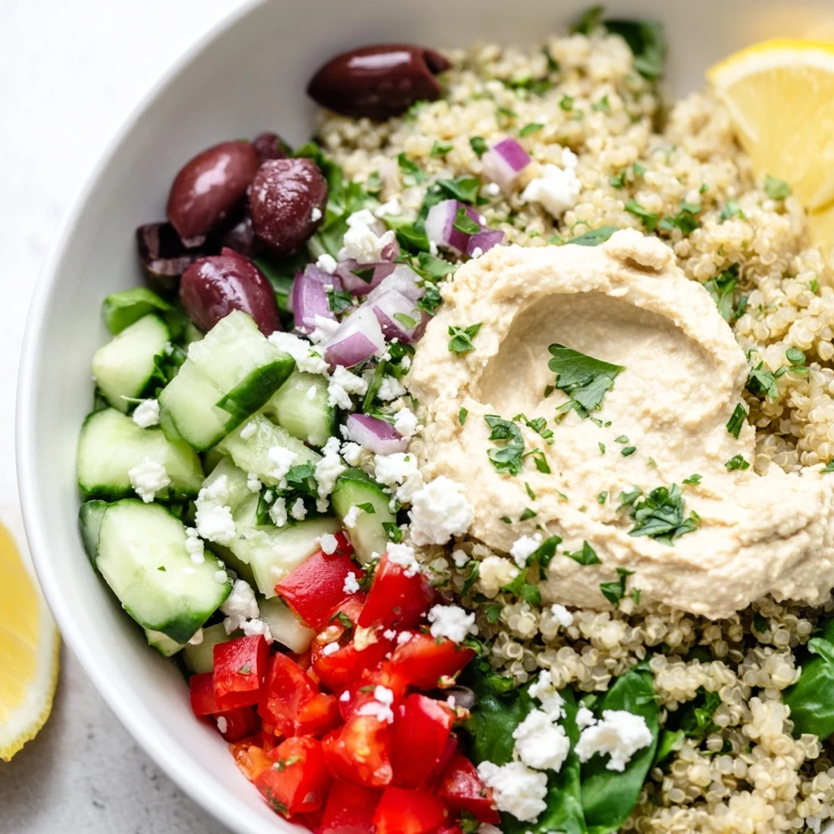 Mediterranean Quinoa Bowl brimming with colorful veggies, creamy hummus, and crumbled feta.