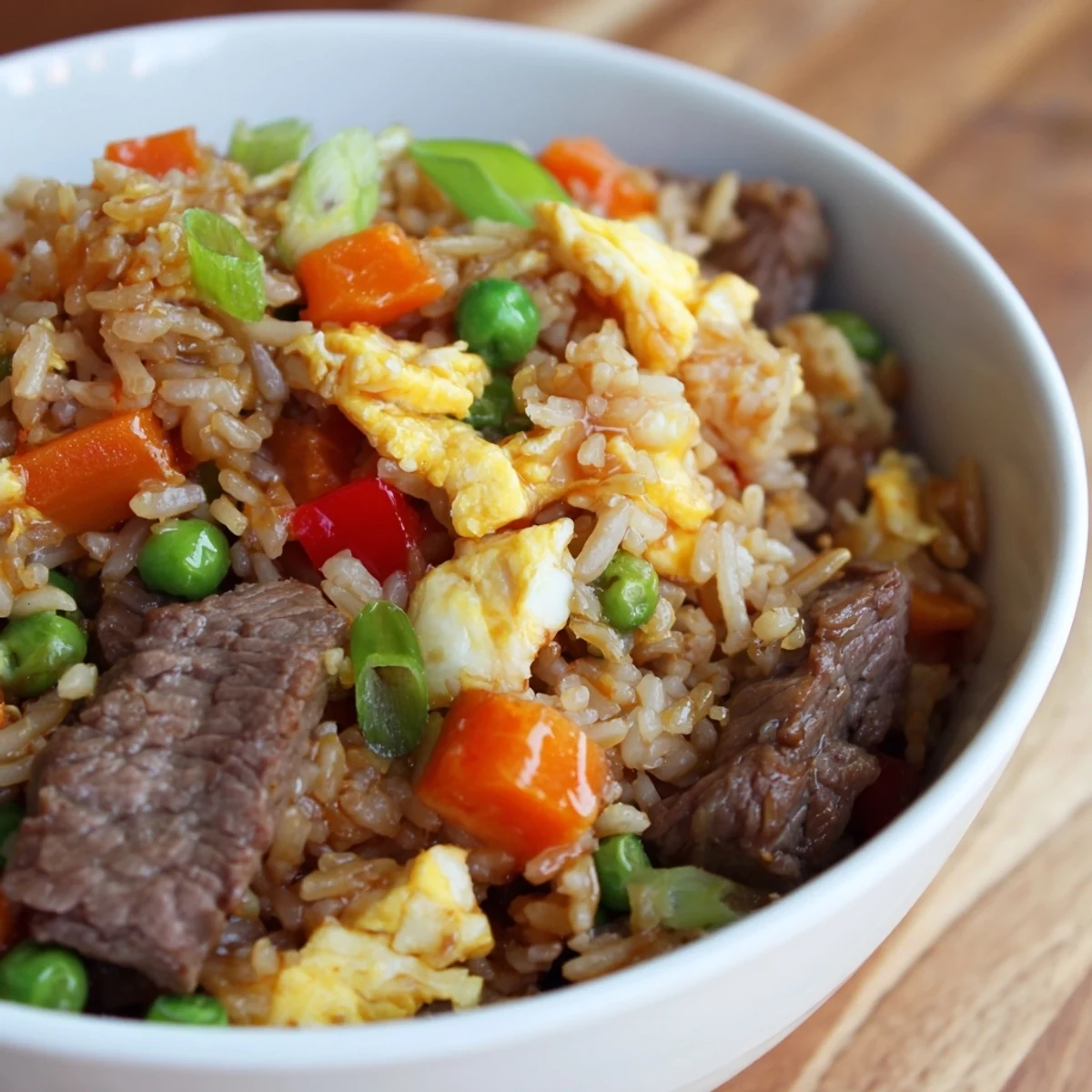 Hearty serving of Beef Fried Rice with Mixed Vegetables and Egg, featuring juicy beef, colorful peppers, and fluffy egg ribbons.