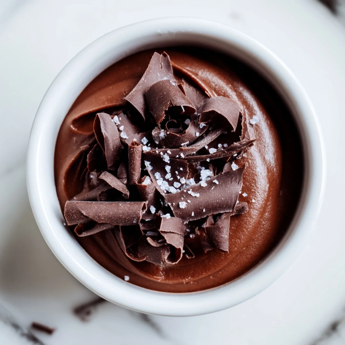 Dark Chocolate Mousse with Sea Salt layered in a dessert glass with a dusting of cocoa.