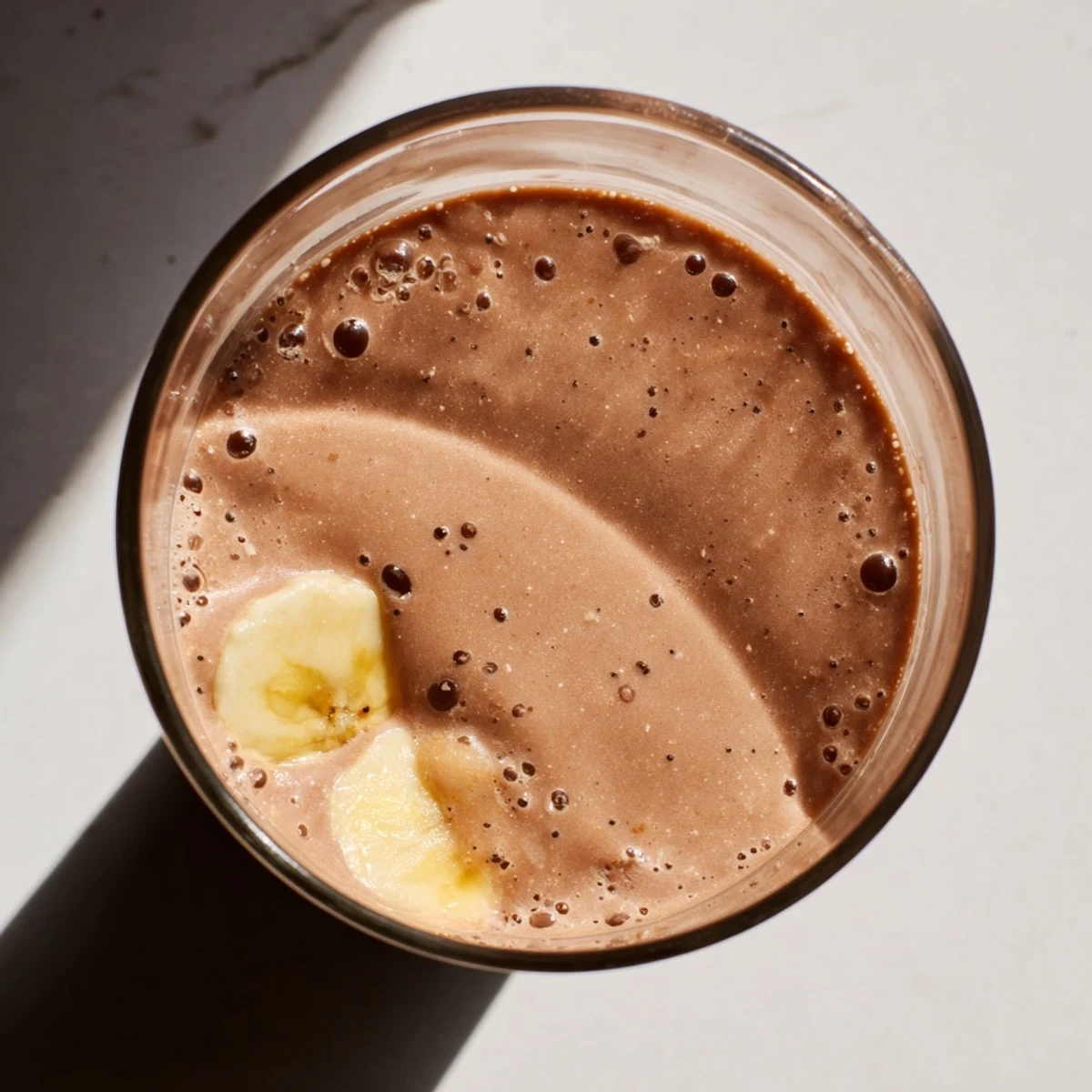 Serving suggestion for Chocolate Peanut Butter Smoothie with Banana, poured over ice and topped with chocolate shavings for extra decadence.  