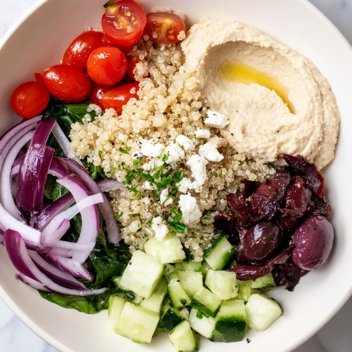 Ready in 35 minutes, this Mediterranean Quinoa Bowl is packed with fresh spinach, peppers, and a lemony dressing.
