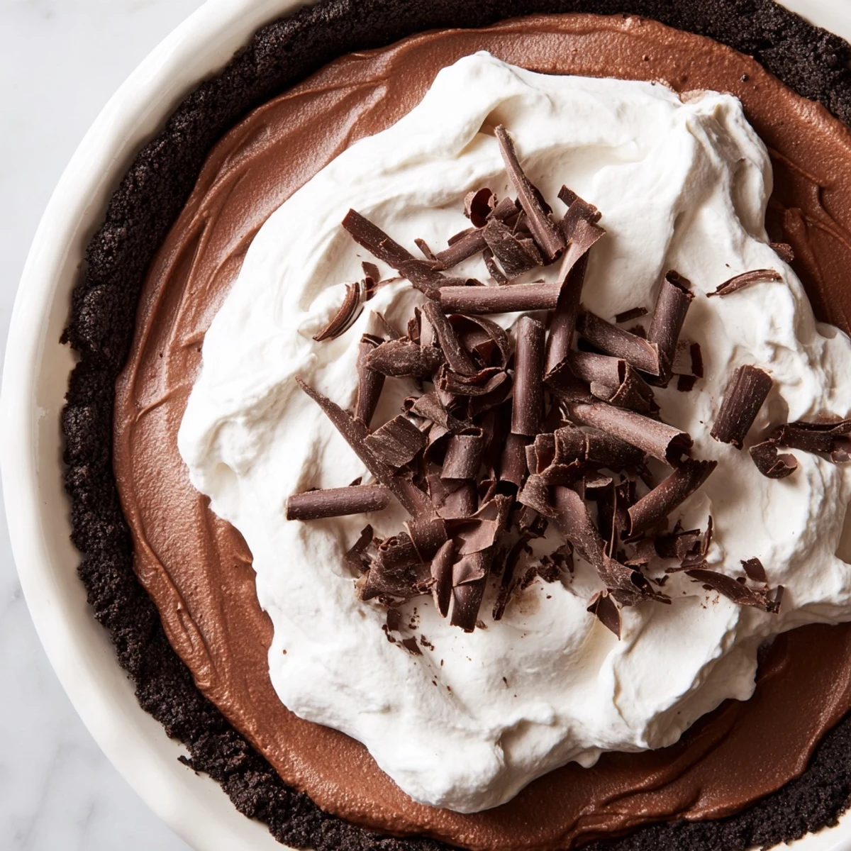 Velvety Romantic Chocolate Silk Pie with a cookie crust and fluffy whipped cream.