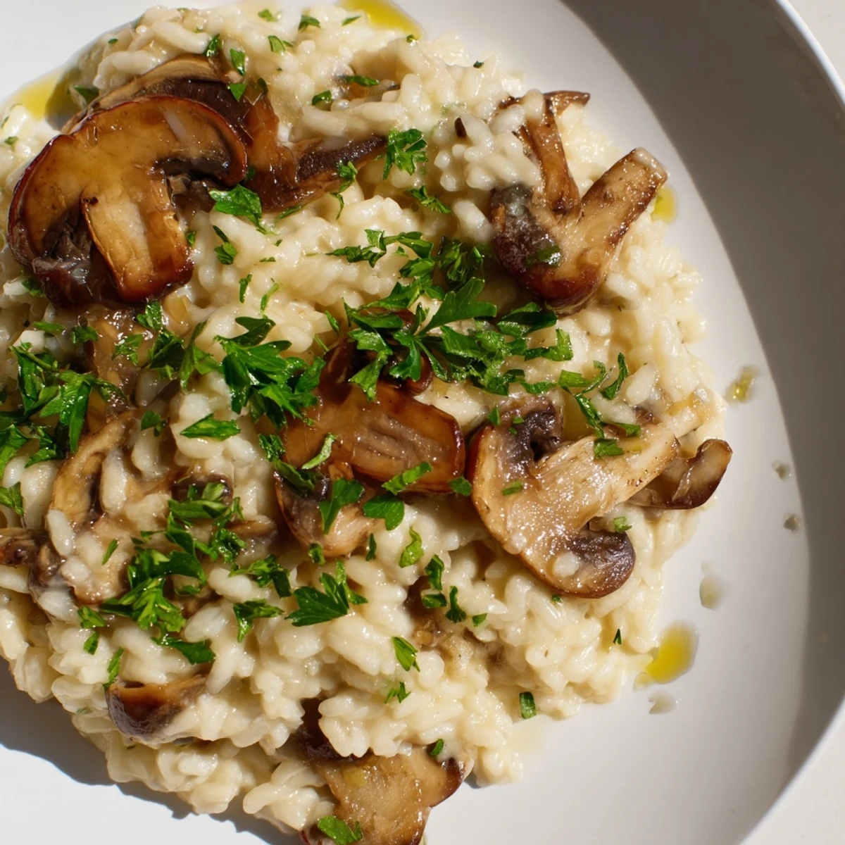 Rich, velvety Italian risotto with mushrooms and truffle oil, paired with white wine for a special meal.