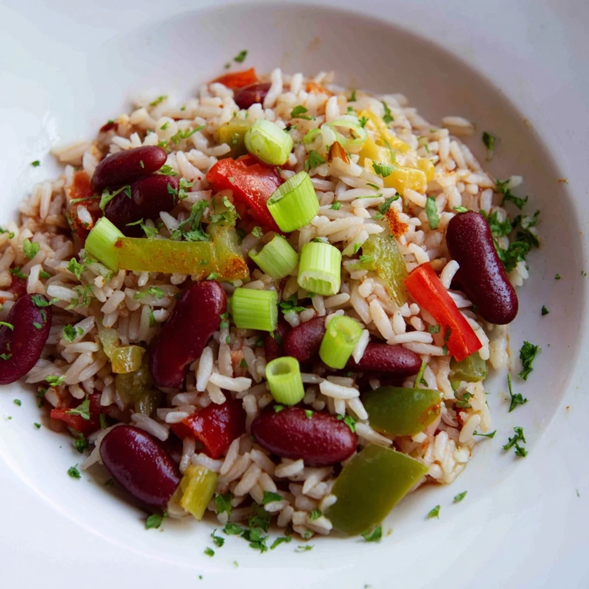 Serving suggestion for Mardi Gras rice and beans, paired with a side of cornbread and a dash of hot sauce.