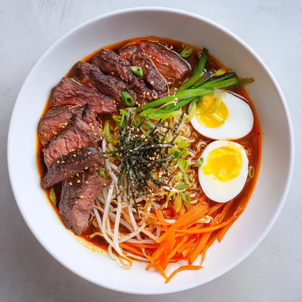 A vibrant bowl of Spicy Beef Ramen with Soft Boiled Egg features tender beef slices and a rich, steaming broth over springy noodles.