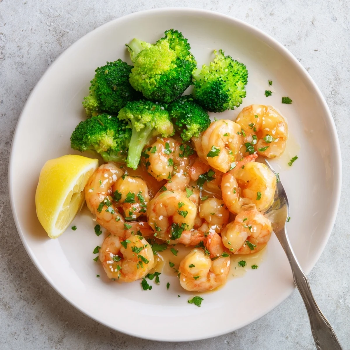 Tender shrimp and bright green broccoli florets coated in a rich honey garlic butter glaze on a rustic plate.