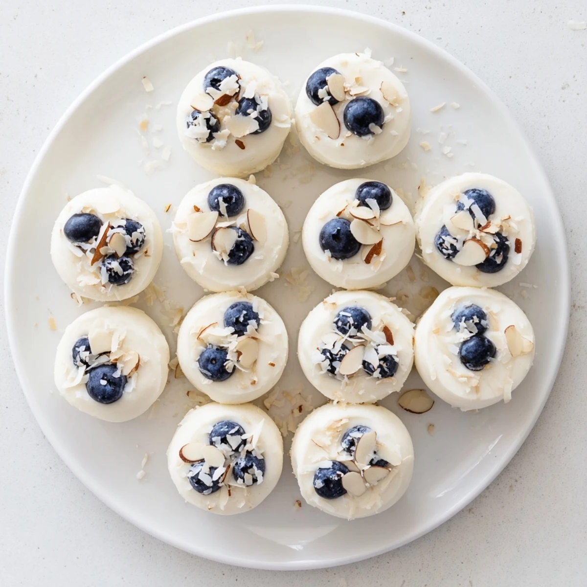 Individual Blueberry Greek Yogurt Bites arranged on parchment paper, ready to serve as a healthy treat.