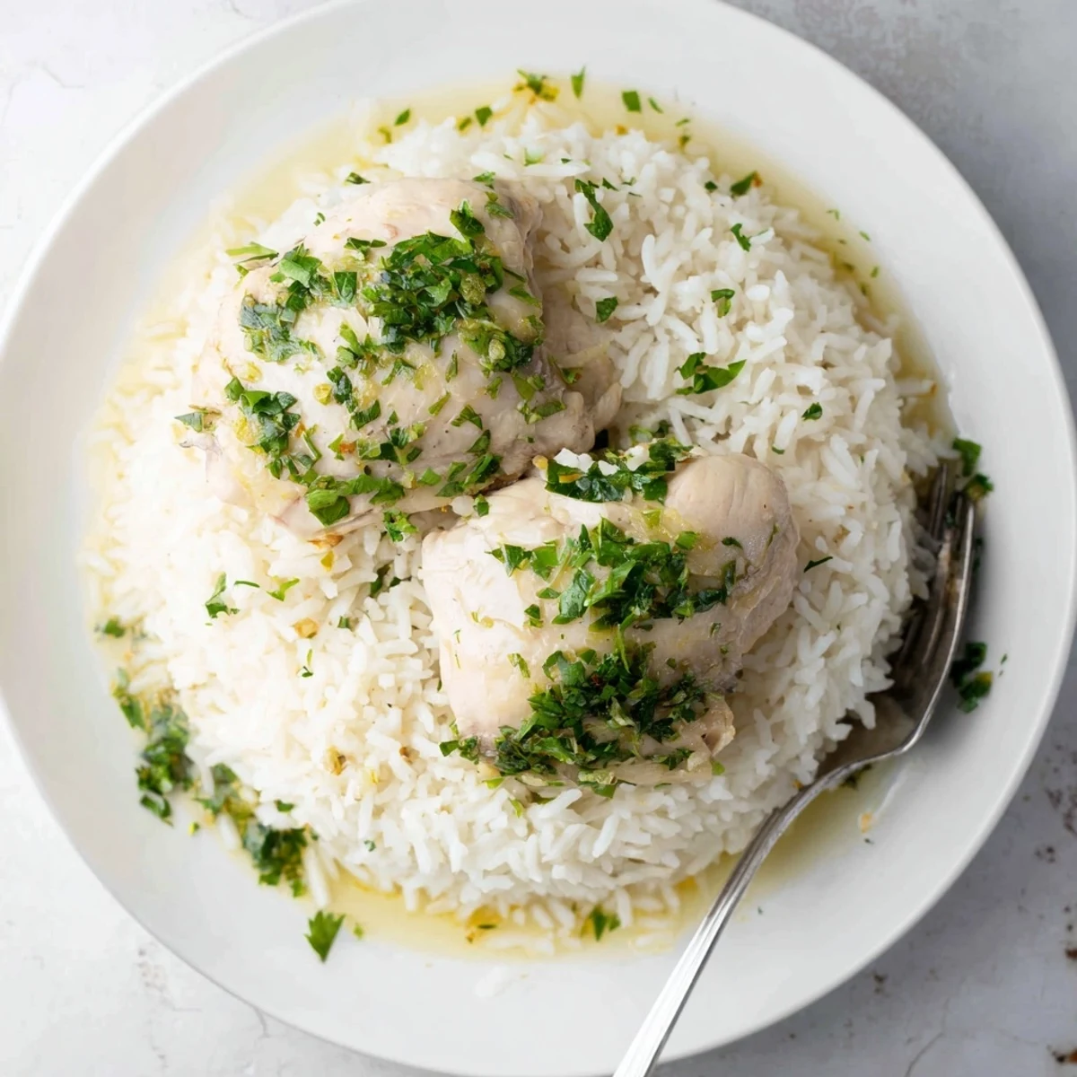 Aromatic slow-cooked chicken infused with lemon and herbs, plated with perfectly fluffy rice for a comforting, gluten-free dinner.
