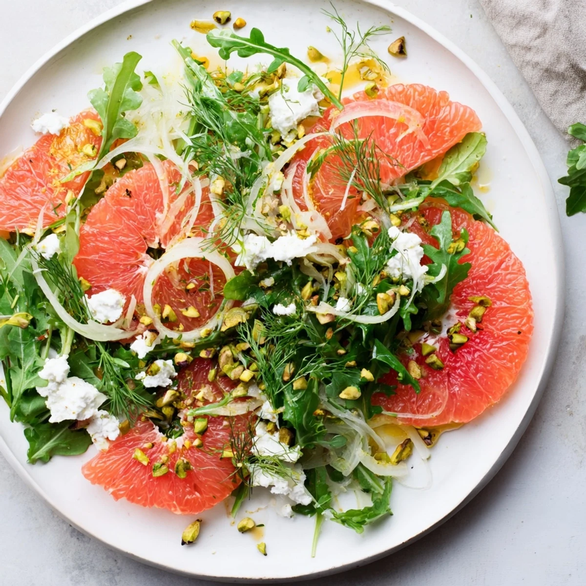 Refreshing Grapefruit Goat Cheese Fennel Salad featuring sliced fennel, juicy grapefruit pieces, and tangy goat cheese sprinkled over mixed greens.