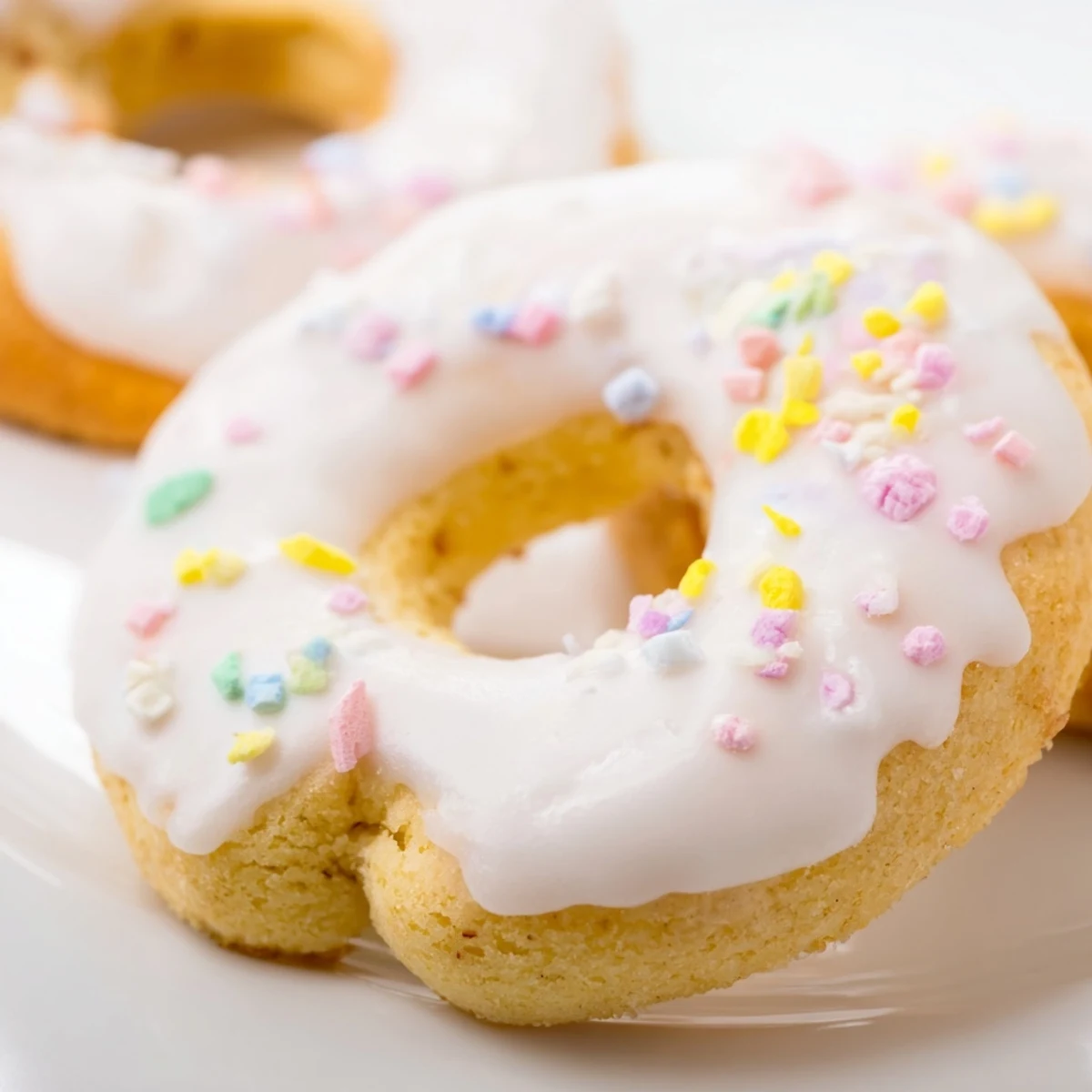 Traditional Italian Easter cookies arranged on a decorative serving platter with lemon zest garnish and confetti decorations