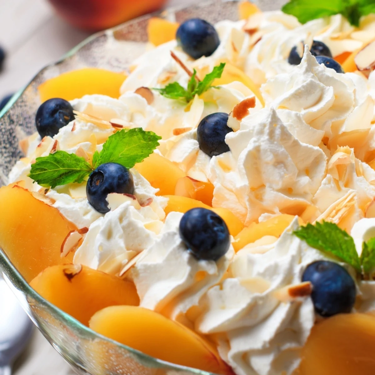 Creamy Peaches and Cream Salad layered with ripe peach slices and fluffy whipped topping