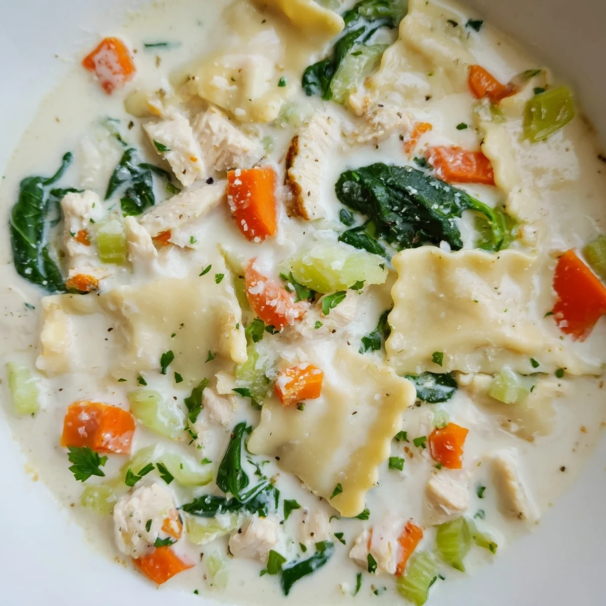 Steaming bowl of Italian white lasagna soup topped with fresh parsley and Parmesan