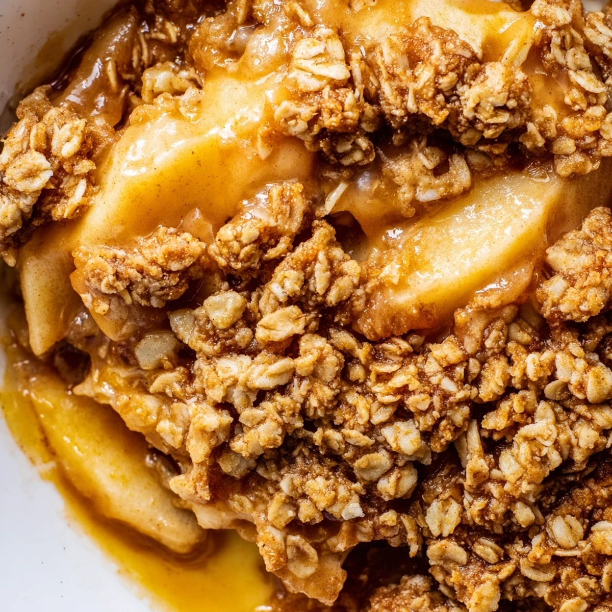 Crockpot apple crisp topped with vanilla ice cream showcasing bubbly baked apple filling