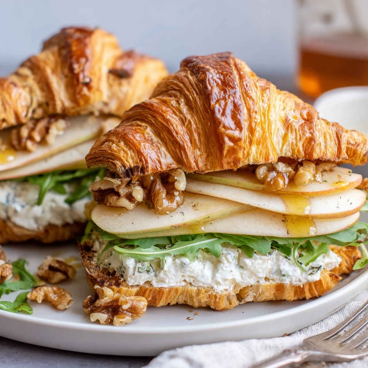 Warm toasted Apple Goat Cheese Croissant Sandwich layered with thin Granny Smith slices