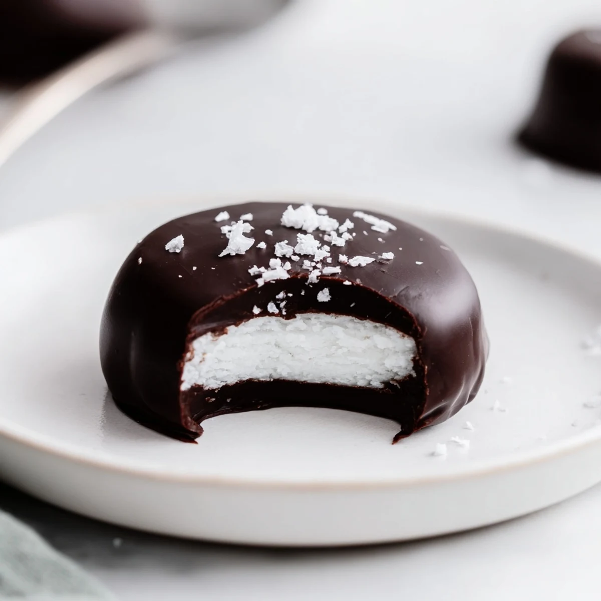 Stacked Peppermint Patties garnished with crushed candy, rich chocolate sheen