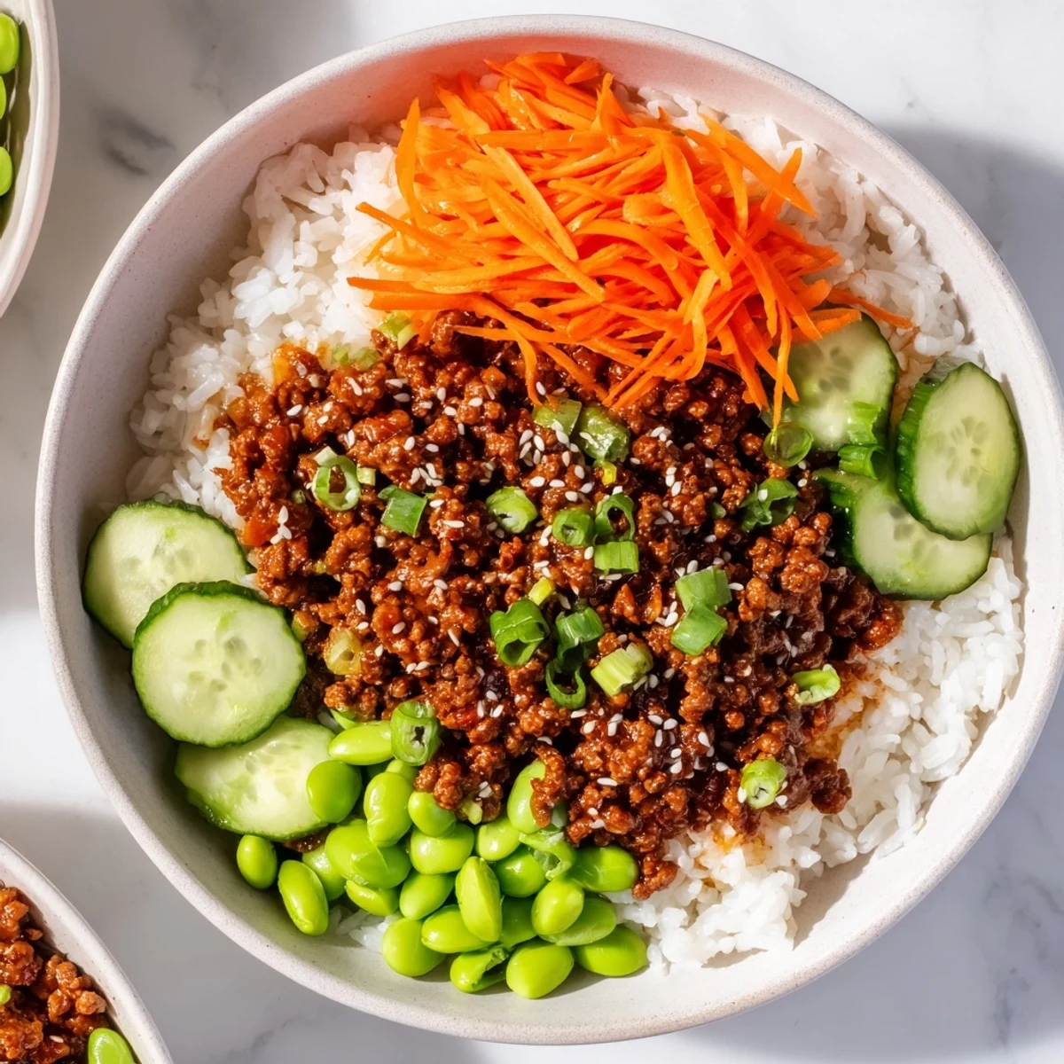 Golden glazed ground beef hot honey bowl over fluffy white rice with colorful fresh vegetable toppings