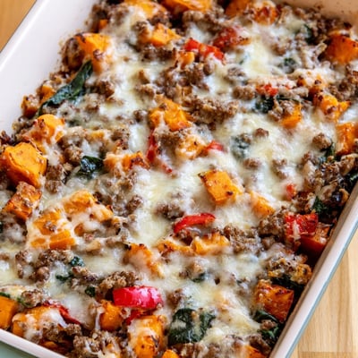 Ground Turkey Sweet Potato Bake served in a white dish, a hearty casserole with spinach and red bell pepper.