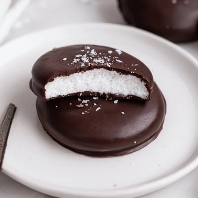 Homemade Peppermint Patties chilled on a tray, mint aroma and snap